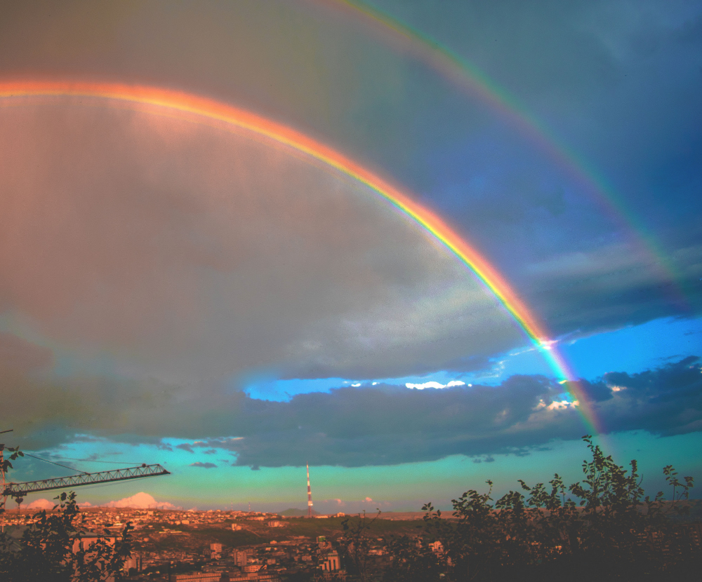 the double rainbow on dark sky